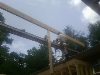 Carpenter setting a ridge beam over a new addition frame — Ice Dam Removal by Roofing Brothers in Dravosburg