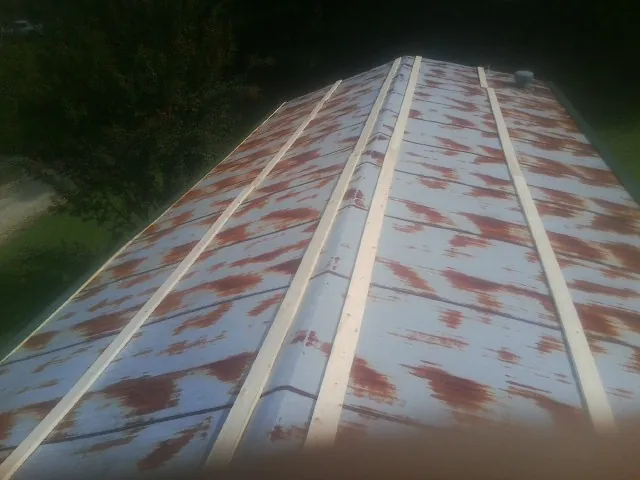 Rusted metal roof panels with new wood purlins before replacement — Storm Damage Roof Repair in Dravosburg by Roofing Brothers