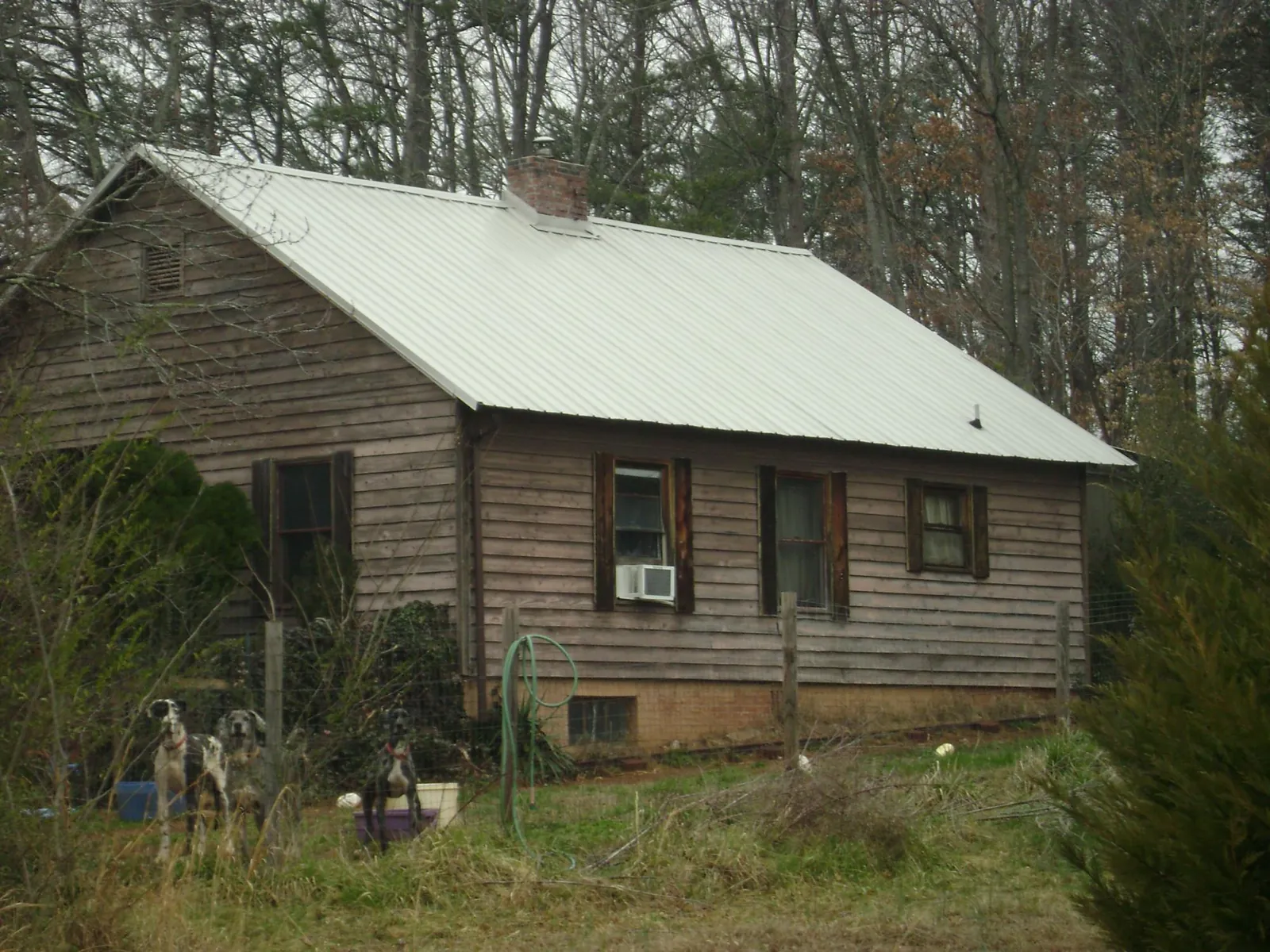 White metal roof on an old wood sided farmhouse, from a Metal Roof Installation job in Dravosburg